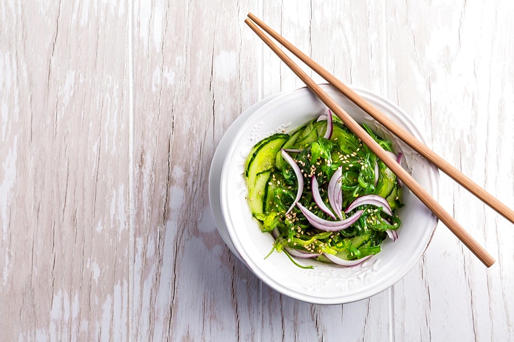 Traditional Japanese Sunomono salad with cucumber and wakame seaweed and sesame seeds