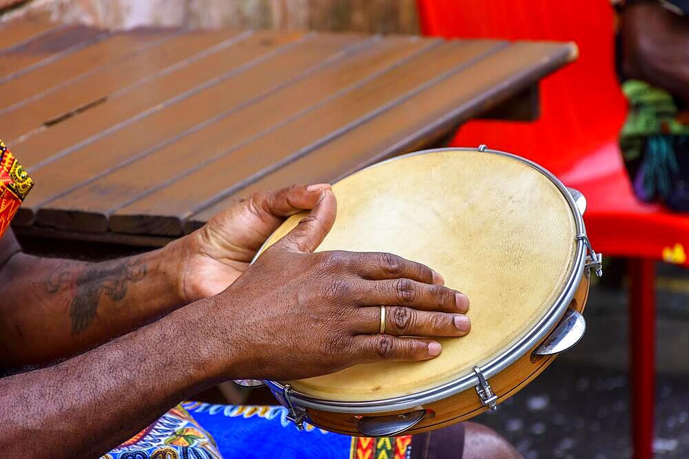 Brazilian samba performance with musician playing tambourine in the streets of Pelourinho, city of Salvador, Bahia, Brasil