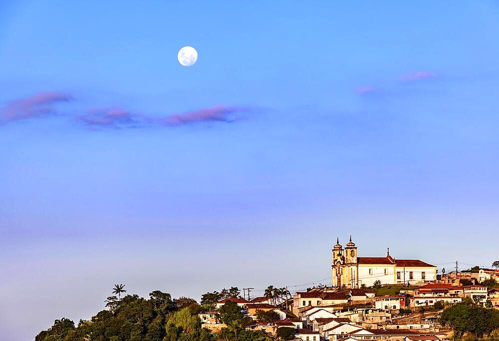 Colonial style church on the mountain with moonlight in the background in the historic city of Ouro Preto in Minas Gerais, Brazil, Brasil, South America