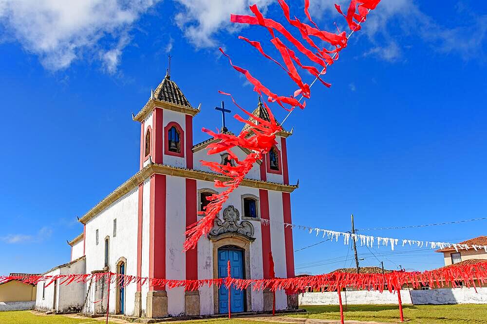 Old and simple colonial-style church decorated with ribbons for a religious celebration in the small town of Lavras Novas, Ouro Preto district in Minas Gerais, Brasil