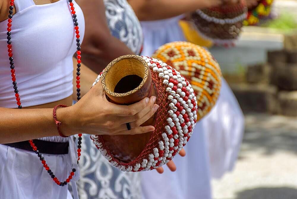 Woman playing a type of rattle called xereque of African origin used in the streets of Brazil during samba performances at carnival, Brasil