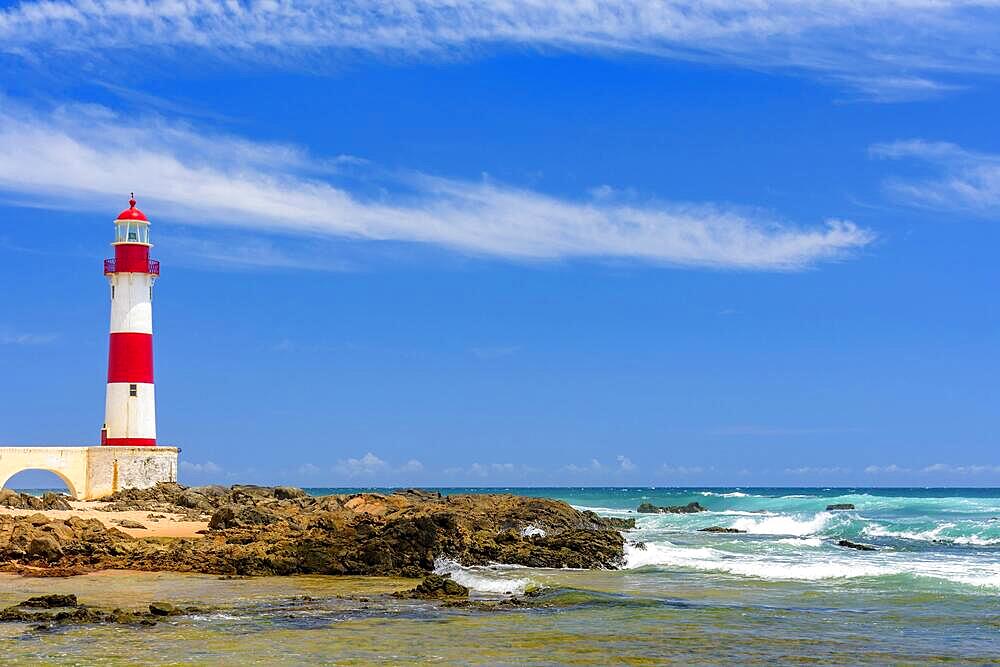 Colorful lighthouse on the sands of the famous Itapua beach in the city of Salvador in Bahia, Brasil