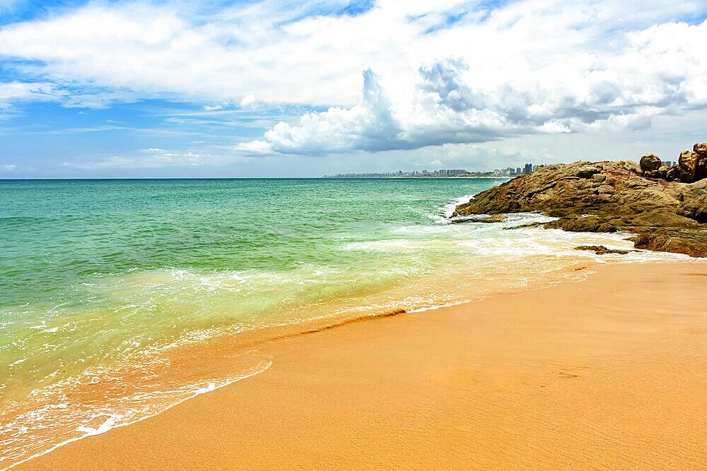 Famous Itapua beach in Salvador with city buildings and horizon in the background, Brasil