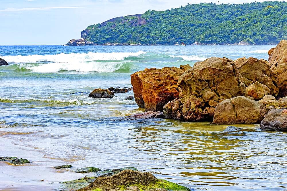 The encounter between the rocks, waves, preserved tropical forest and the sea in Trindade on the southern coast of the state of Rio de Janeiro, Brazil, Brasil, South America