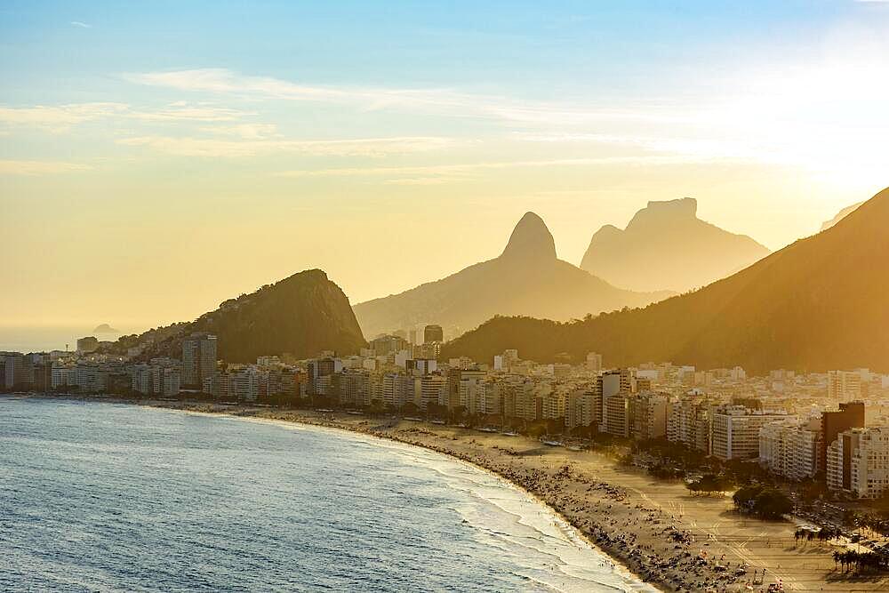 Golden sunset between Copacabana buildings and hills, Praia de Copacabana, Rio de Janeiro, Rio de Janeiro, Brasil