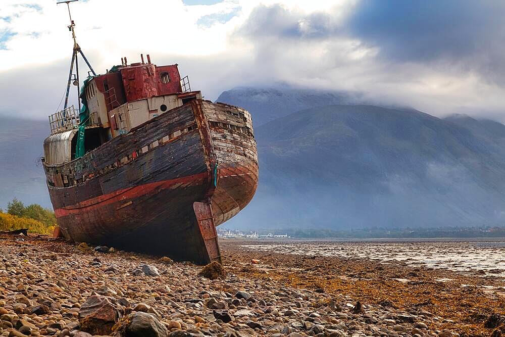 Stranded fishing boat and Ben Nevis from the shore of Loch Linnhe, Corpach, near Fort William, Highlands, Scotland, United Kingdom, Europe