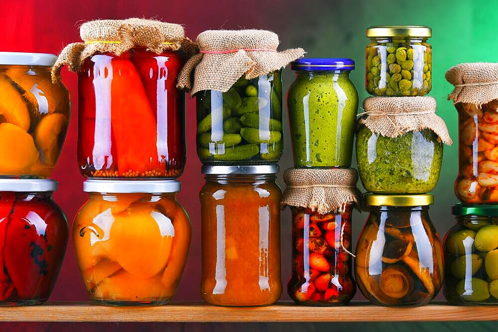 Jars with variety of pickled vegetables and fruits. Preserved food