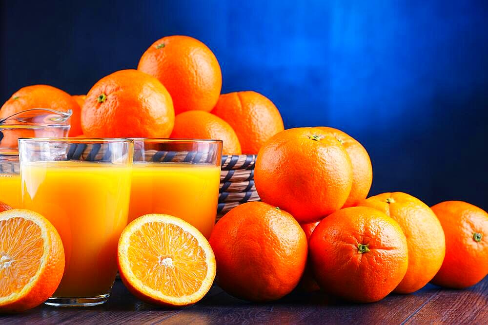 Glasses with freshly squeezed orange juice and fruits