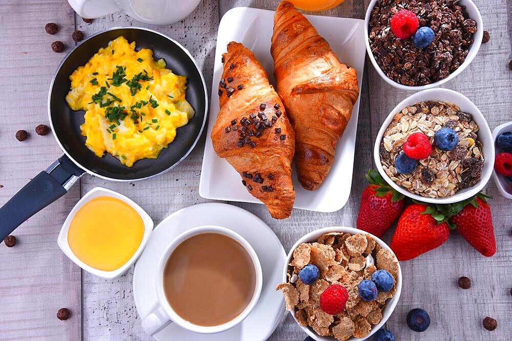 Breakfast served with coffee, orange juice, croissants, egg, cereals and fruits. Balanced diet