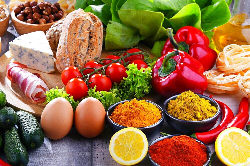 Composition with assorted organic food products on wooden kitchen table