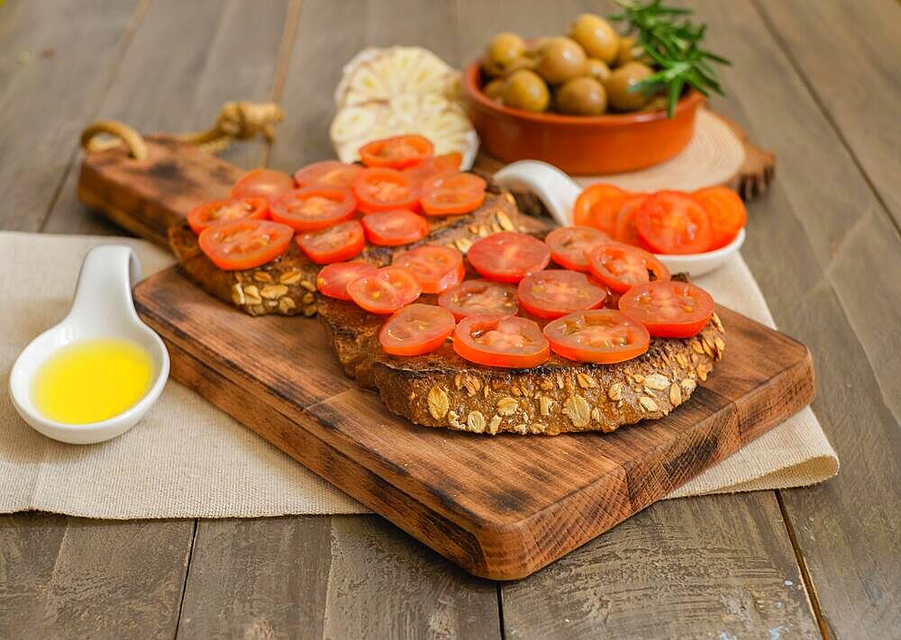 Toast bread with cherry tomato and olive oil with rosemary