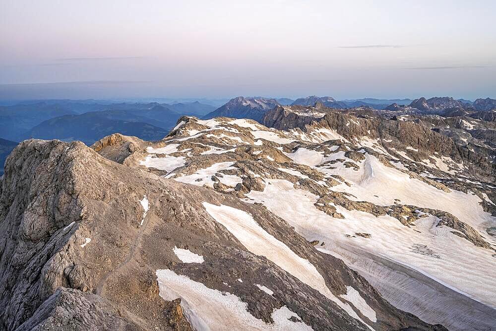 View of rocky plateau with snow and glacier at sunrise, on the Hochkoenig, Uebergossene Alm, view of the Steinernes Meer, Berchtesgaden Alps, Salzburger Land, Austria, Europe