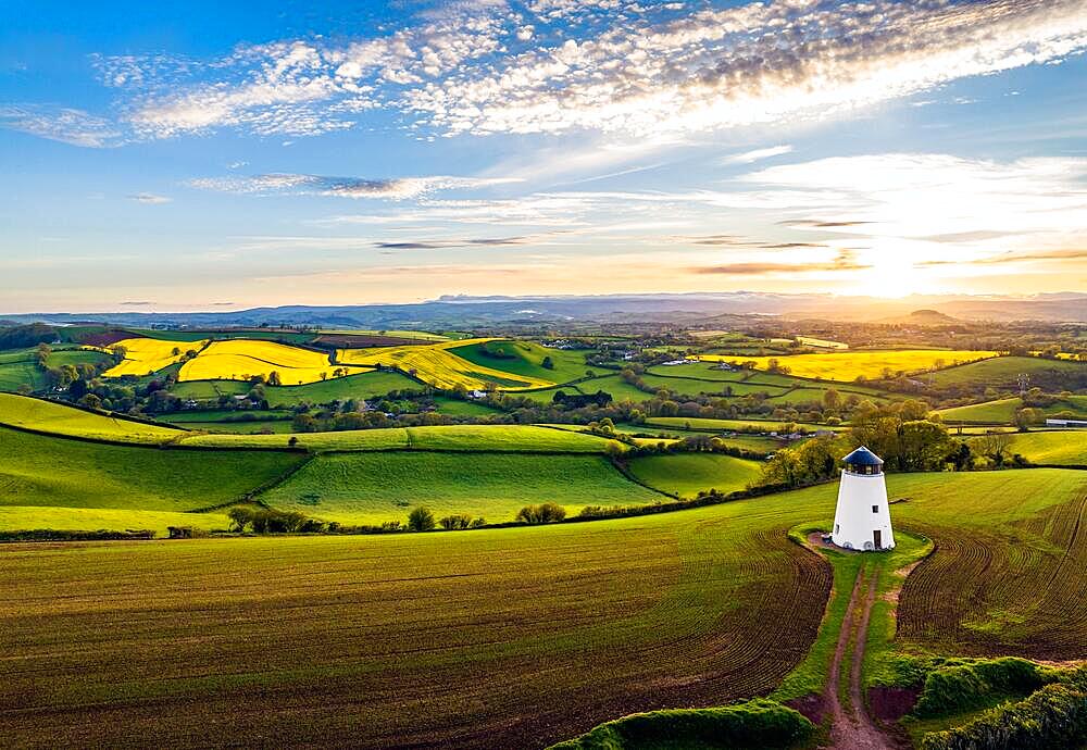 Sunset over Devon Windmill from a drone, fields and farms, Torquay, Devon, England, United Kingdom, Europe