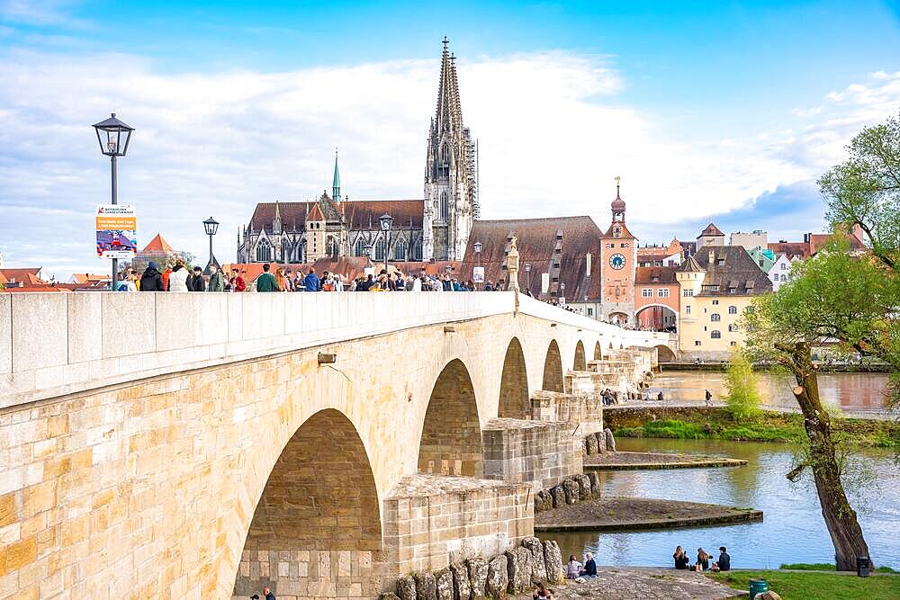 Bridge with many people and cathedral in the background, Regensburg, Bavaria, Germany, Europe