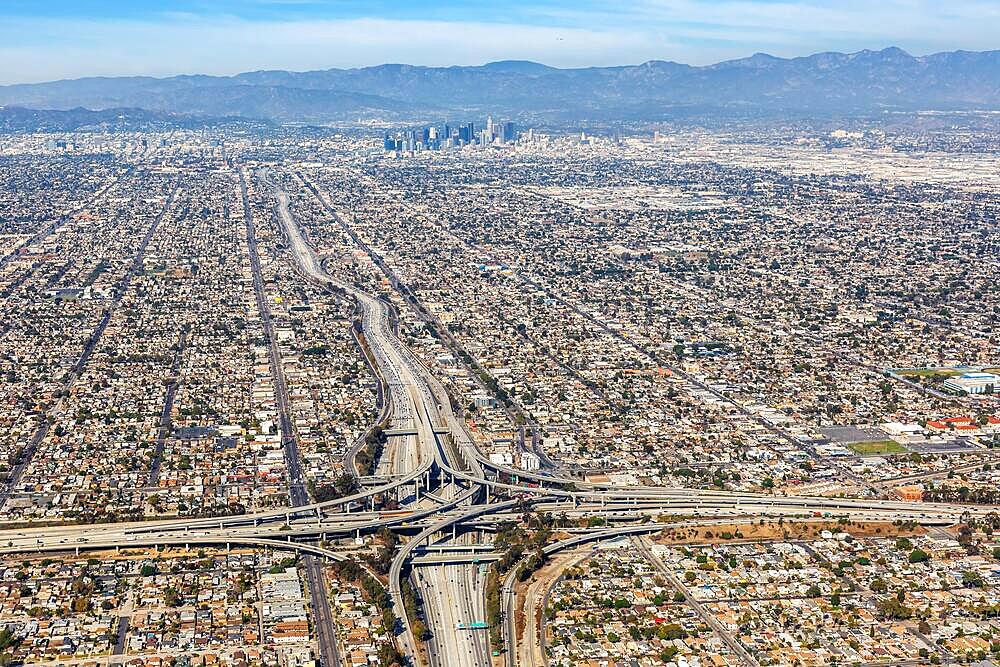 Aerial view of Harbor interchange and Century Freeway traffic with downtown Los Angeles, USA, North America