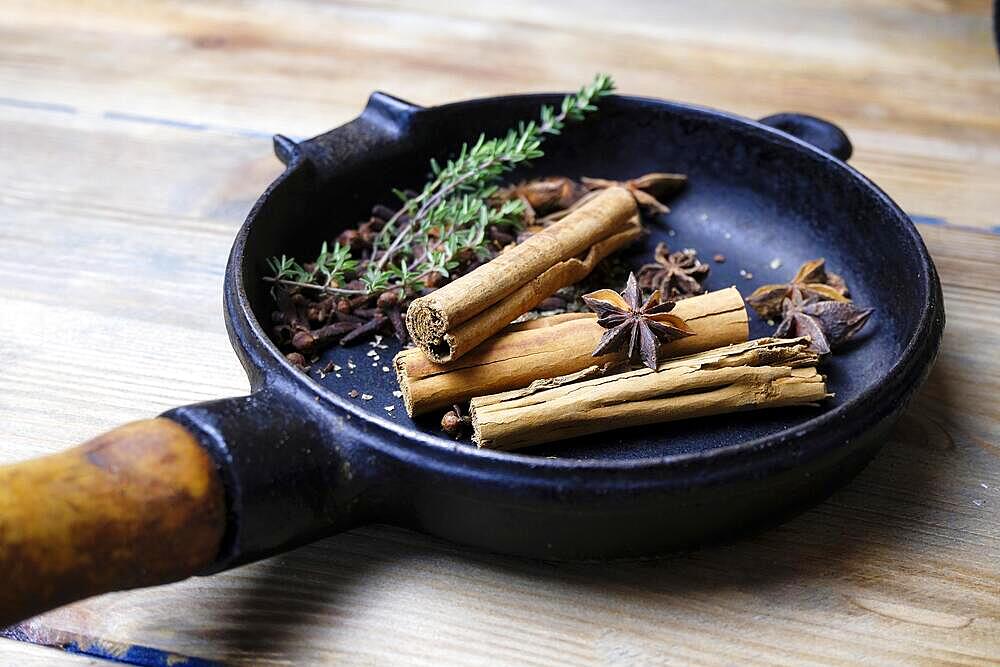 Cinnamon sticks and star anise in a pan