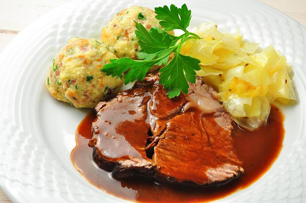 Roast beef with bread dumplings and white cabbage