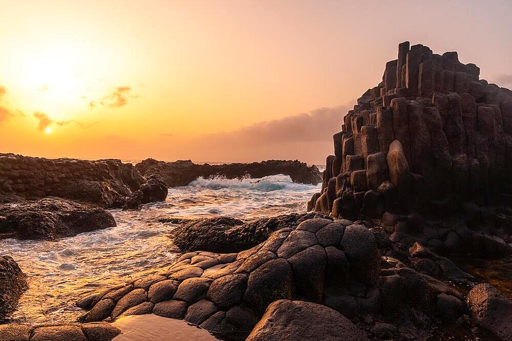 El Hierro Island. Canary Islands, landscape of volcanic rocks in the natural pool of Charco Azul in the orange sunset