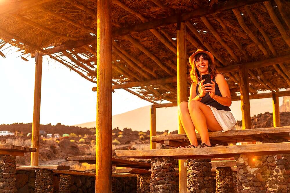 A female tourist at sunset smiling on Tacoron beach on El Hierro, Canary Islands