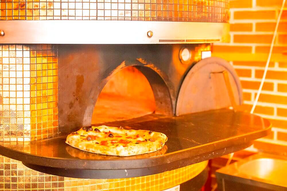 Artisan pizza oven. Pizza fresh out of the oven, pizza hot and ready for customers