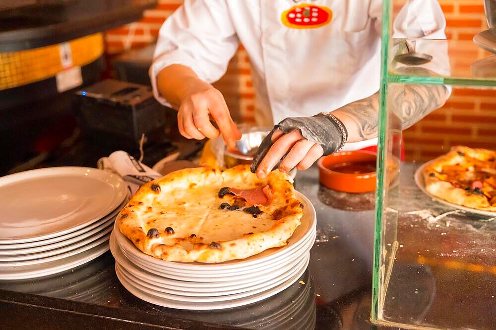 Artisan pizza oven. Chef preparing the pizza to sell it, pizza hot and ready for customers