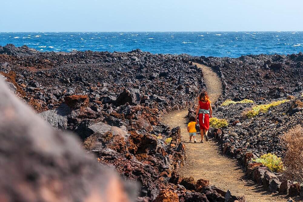 Walking along the beautiful volcanic path in the town of Tamaduste on the coast of the island of El Hierro, Canary Islands, Spain, Europe