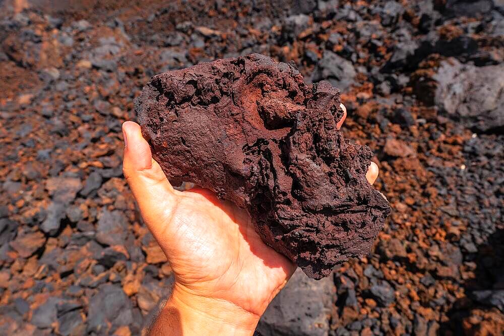 Detail of the red stones on the volcanic trail in the town of Tamaduste on the coast of the island of El Hierro, Canary Islands, Spain, Europe