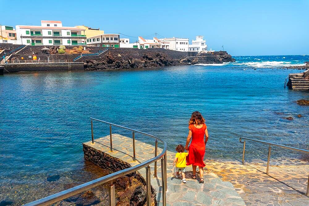 A mother and her son in the seaside tourist village Tamaduste on the island of El Hierro, Canary Islands, Spain, Europe