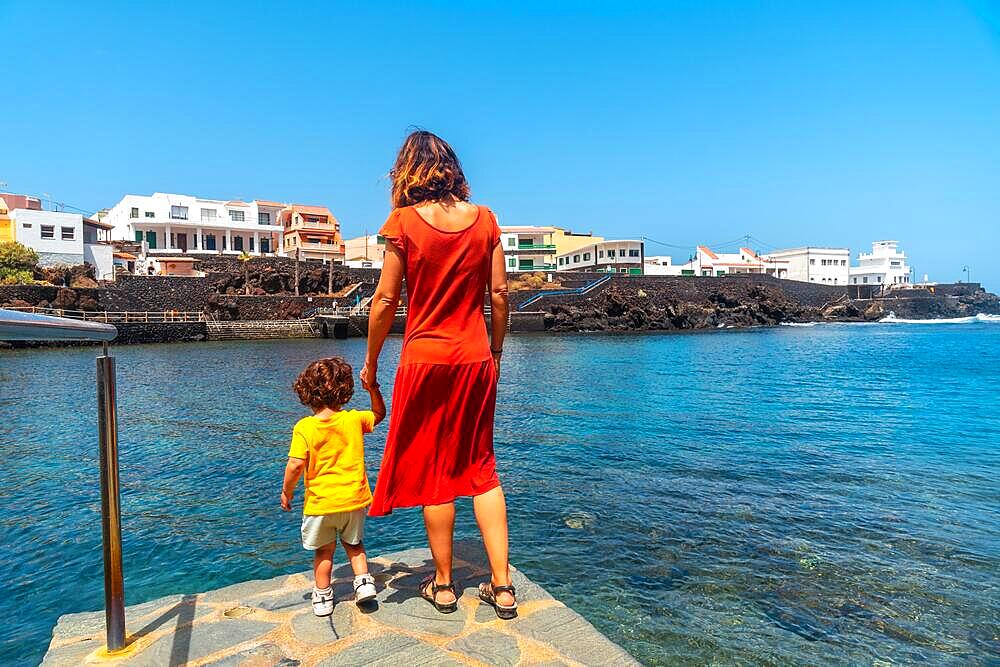 A mother and son on holiday in the seaside tourist village of Tamaduste on the island of El Hierro, Canary Islands, Spain, Europe