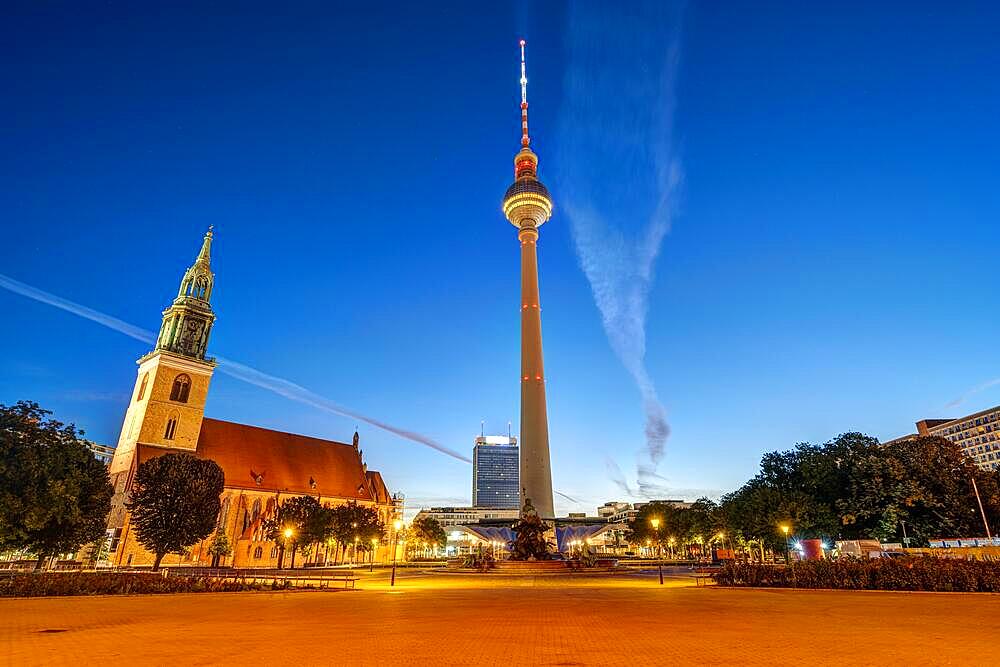 The famous Alexanderplatz in Berlin with St. Mary's Church and the TV Tower at dawn