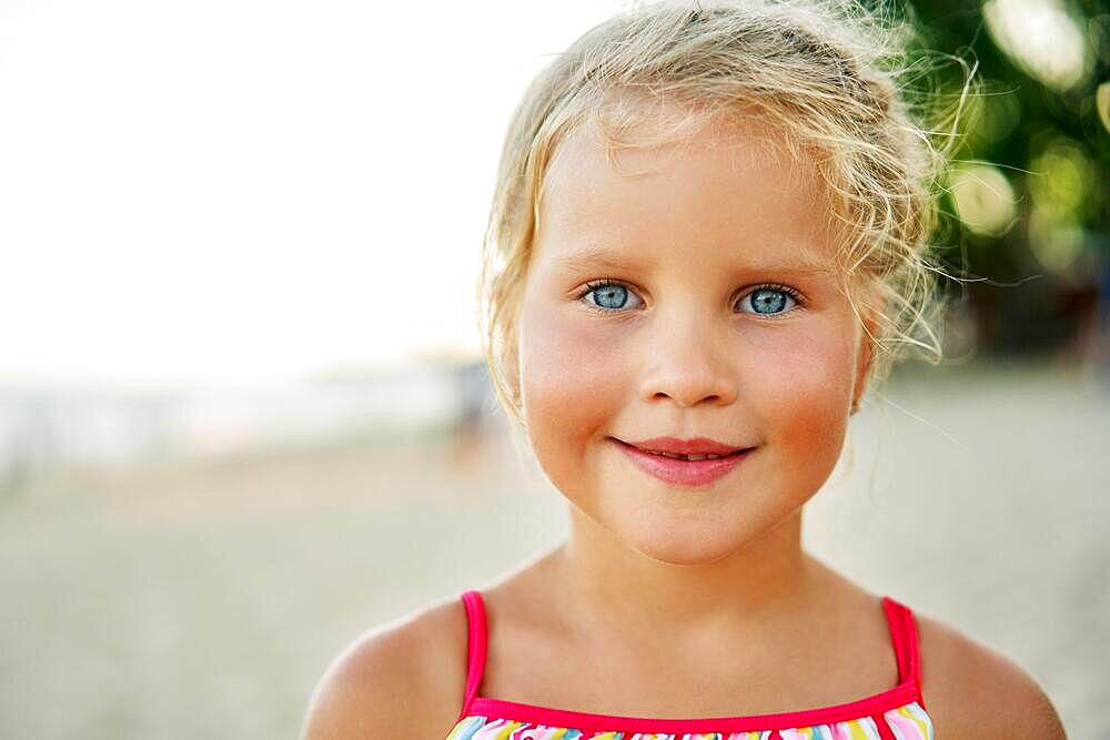 Close up portrait of happy cute little girl. Smiling blonde child on summer. adorable kids, childhood, emotions concept