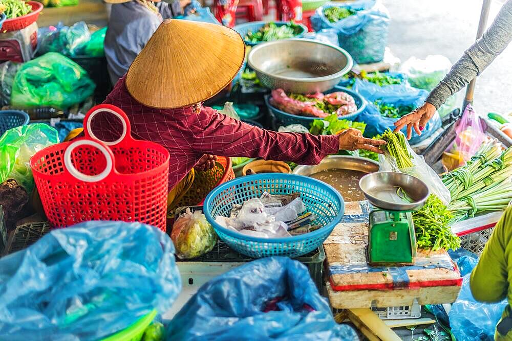 Women selling food on the street of Hoi An in Quang Nam Province, Vietnam, Asia