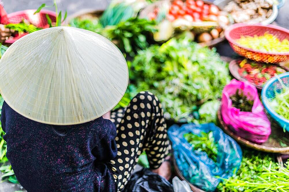 Women selling food on the street of Hoi An in Quang Nam Province, Vietnam, Asia