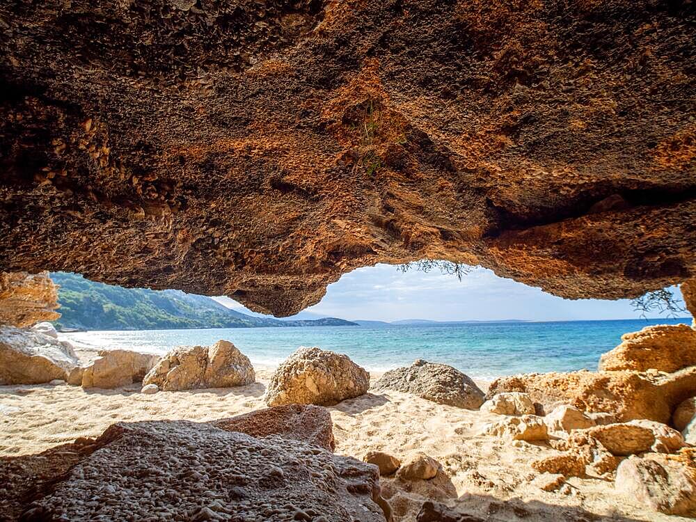 Karst cave on the sandy beach near the campsite of Stara Baska, Stara Baska, Island of Krk, Kvarner Gulf Bay, Primorje-Gorski kotar, Croatia, Europe