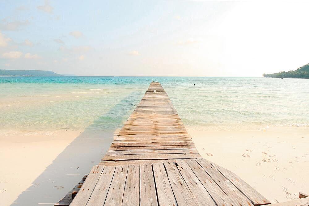 A wooden boardwalk leading to the white sand beach of Koh Rong Samloen Island in Cambodia