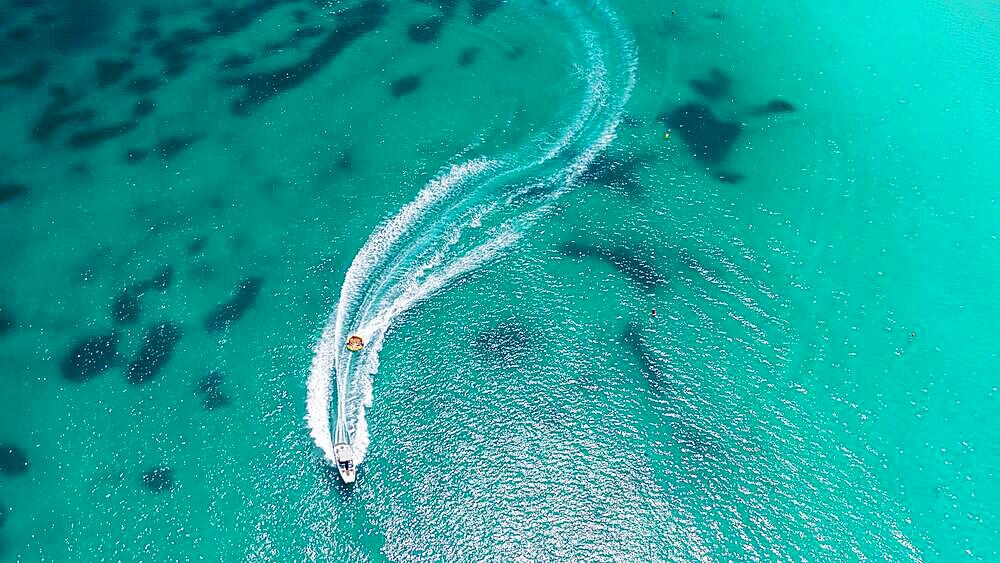 Aerial view on motorboat and jetski on the sea surface