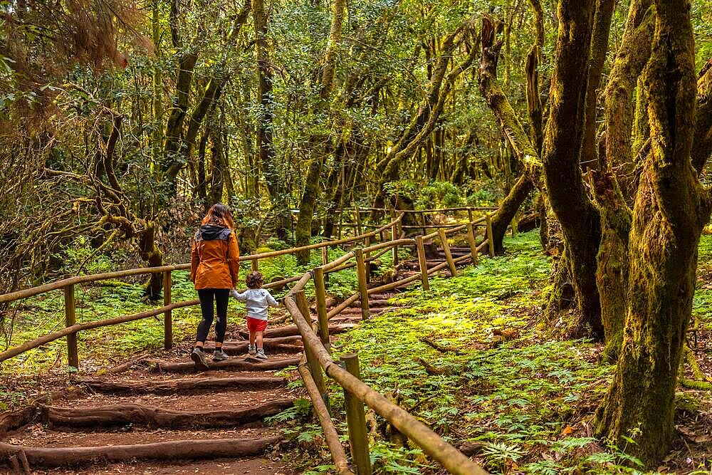 Mother and son climbing some stairs along a path in the Garajonay natural park on La Gomera, Canary Islands