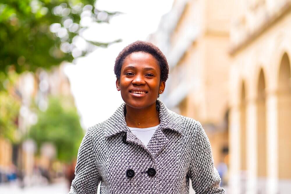 African ethnicity business woman in the city, portrait of finance woman walking on the street