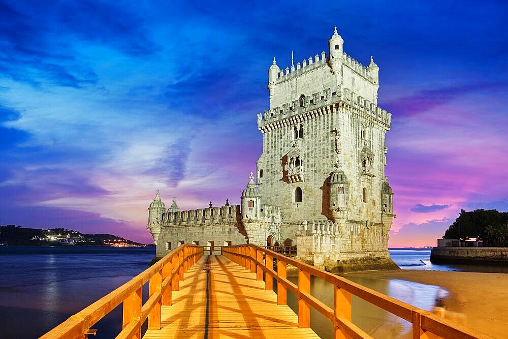 Belem Tower or Tower of St Vincent, famous tourist landmark of Lisboa and tourism attraction, on the bank of the Tagus River (Tejo) after sunset in dusk twilight with dramatic sky. Lisbon, Portugal, Europe