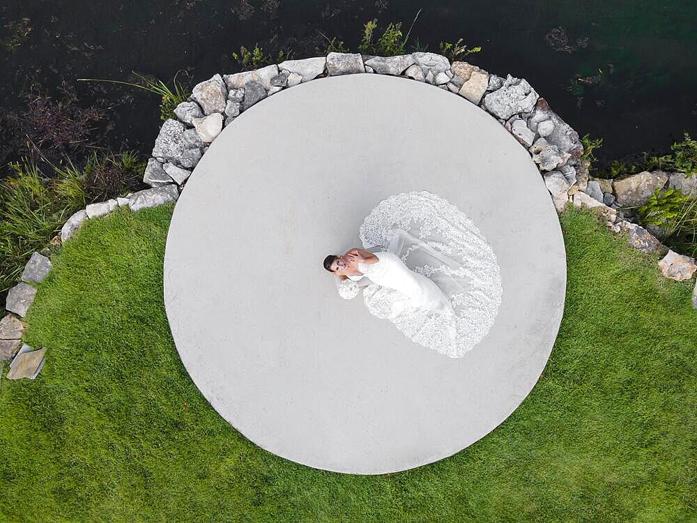 A gorgeous brunette bride poses in her wedding dress before the big day