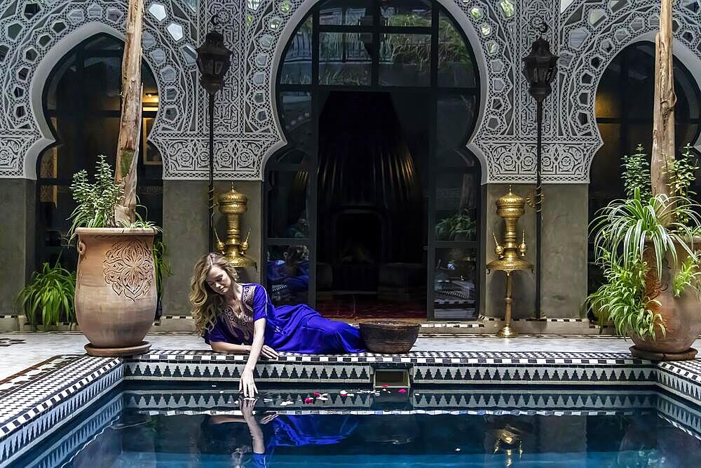 A gorgeous model poses inside a home environment in Medina, Morocco, Africa