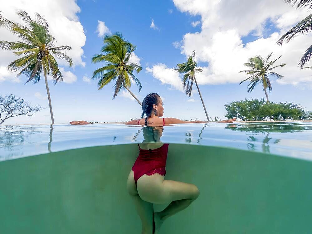 A gorgeous latin model enjoys swimming in a pool on the Gulf of Mexico near Sinanche Yucatan Mexico