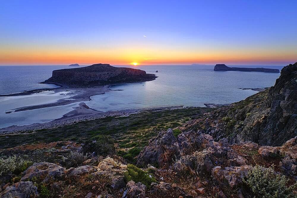 Beautiful sunset view of Cape Tigani and Gramvousa islet from Balos beach, Crete, Greece. Sundown and rich colors of rocky slopes and greenery