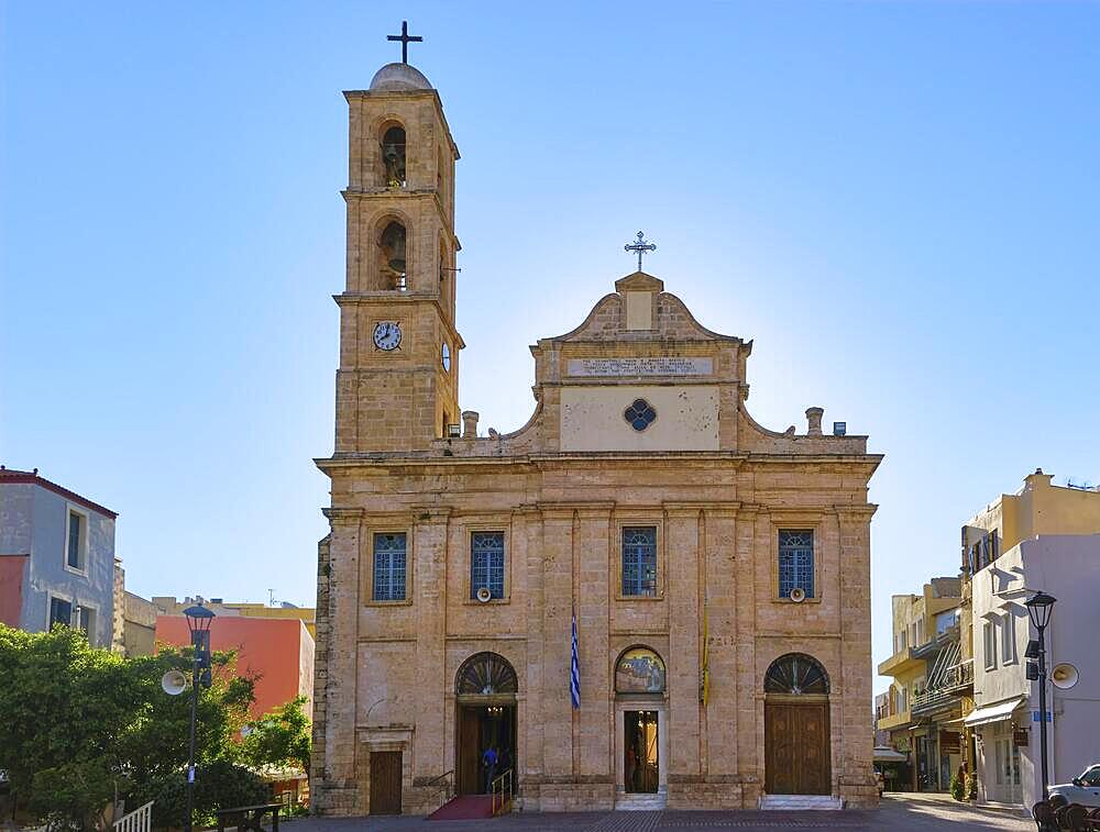 Holy Metropolitan Church and Greek Orthodox cathedral of presentation of the Virgin Mary in Chania, Crete, Greece in morning. Bright sunlight, blue sky. Frontal shot of facade, traditional christian architecture. Doors open for morning holy service