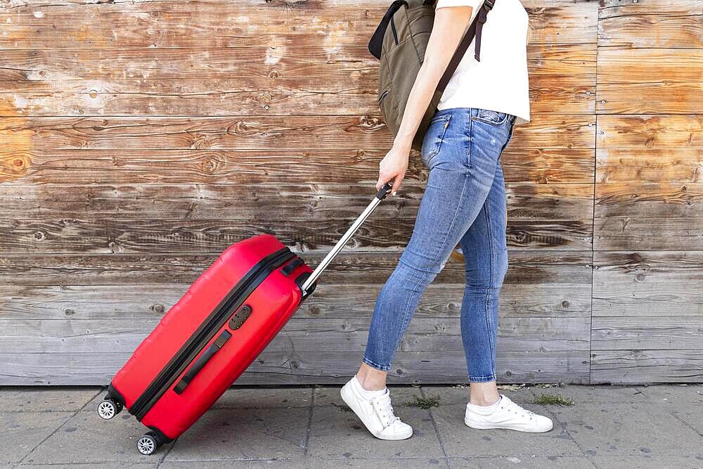 Side view woman with her luggage