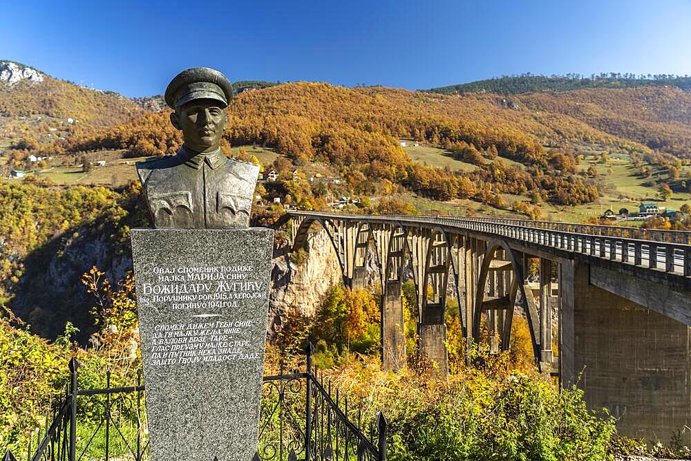 Statue of planner Mijat S. Trojanovic in front of the Tara Bridge in autumn, Pljevlja, Montenegro, Europe