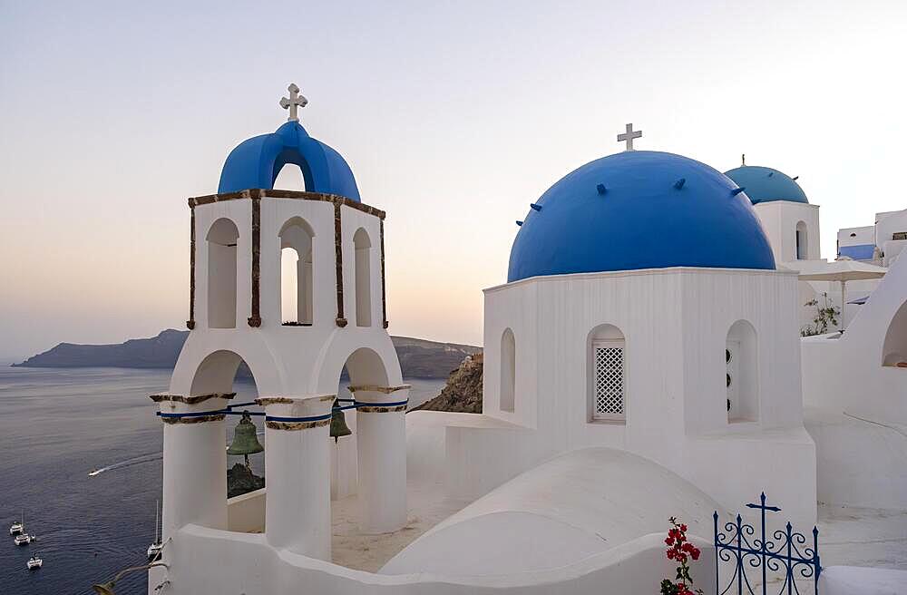 White churches with blue dome, Agios Spiridonas, St Spyridon) and Church of Anastasis, Resurrection, Ia, Oia, Santorini, Greece, Europe