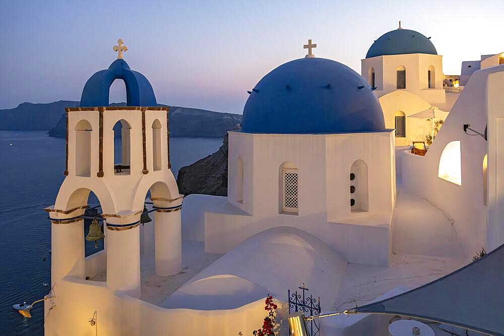 Two blue-domed churches, Agios Spiridonas, St Spyridon) and Church of Anastasis, Resurrection, at nightfall, Ia, Oia, Santorini, Greece, Europe