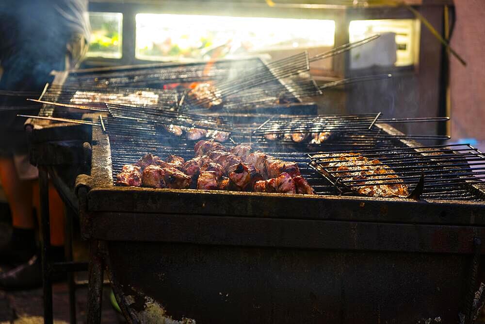 Fish and meat on a grill of a restaurant in the old town of Lisbon, Portugal, Europe