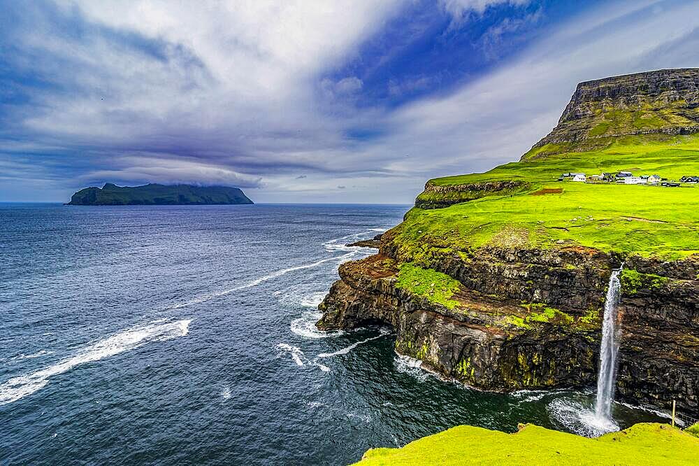 Gasadalur waterfall into the ocean, Vagar, Faroe islands, Denmark, Europe